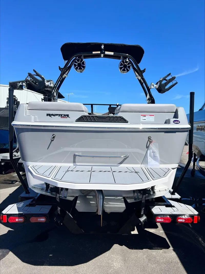 Slide: The Image of 2024 Moomba Craz boat rear view with Raptor engine and wakeboard tower. - 2