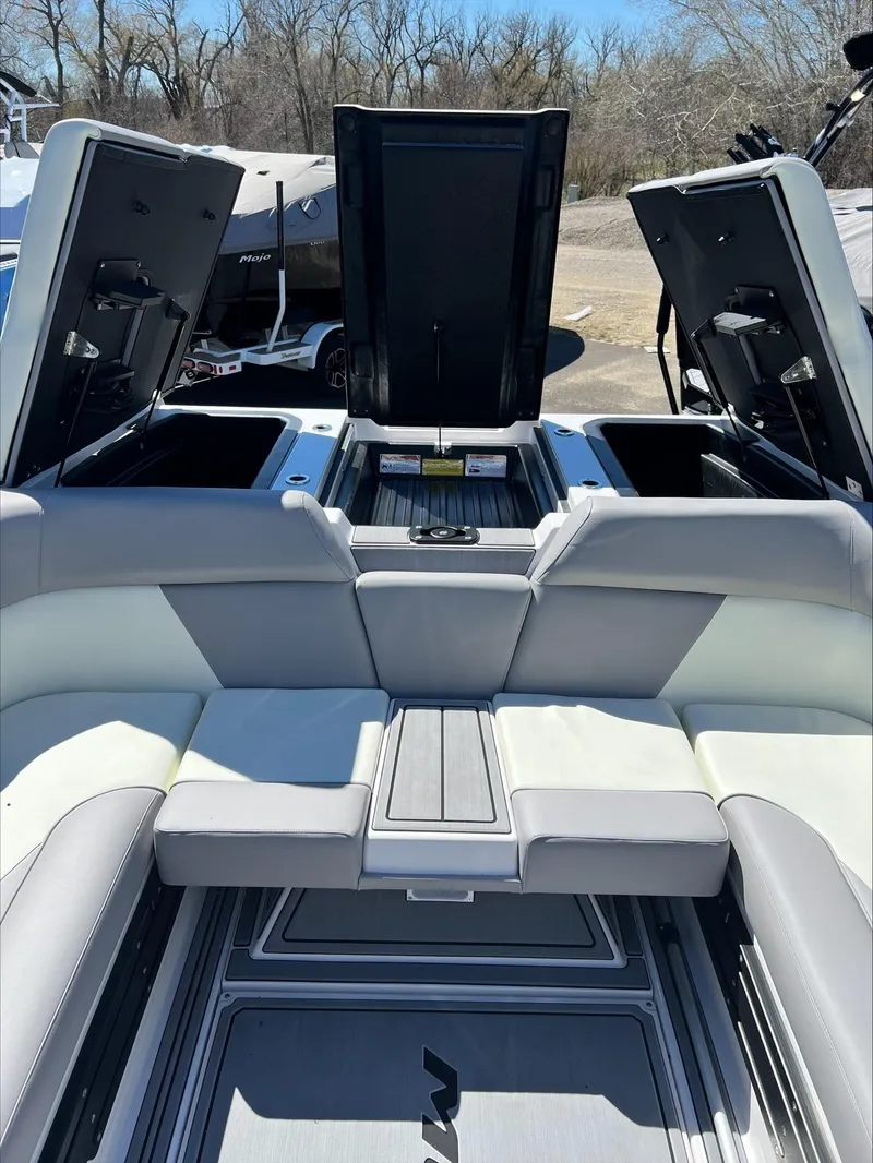 Slide: The Image of 2024 Moomba Craz boat interior with open storage compartments and cushioned seating. - 4