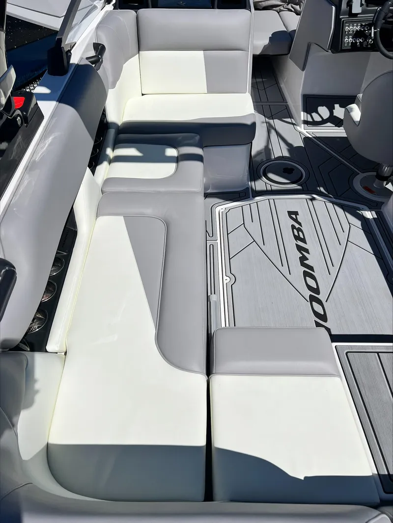 Slide: The Image of 2024 Moomba Craz boat interior with gray and white seating and branded flooring. - 6