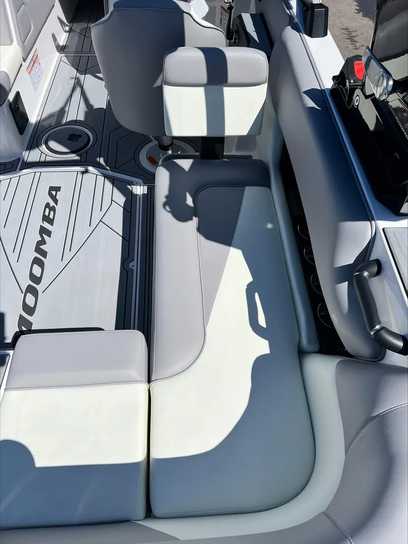 Slide: The Image of 2024 Moomba Craz boat interior with gray and white seating and flooring. - 7