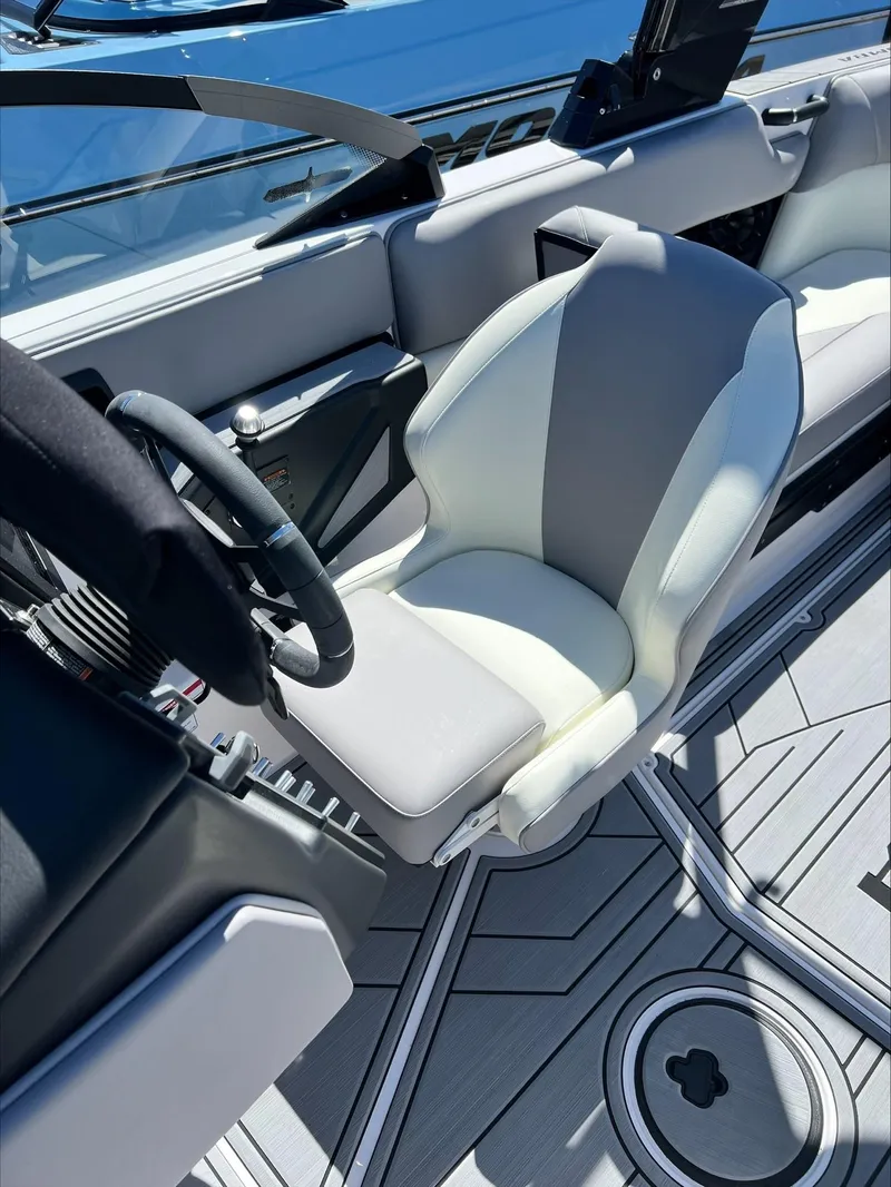 Slide: The Image of 2024 Moomba Craz boat interior with steering wheel and captain's seat. - 9
