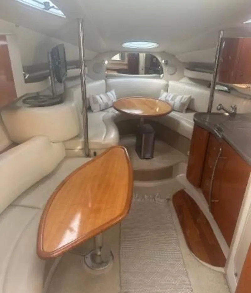Slide: The Image of Interior of 2001 Doral 330se yacht with wooden tables and white seating. - 11