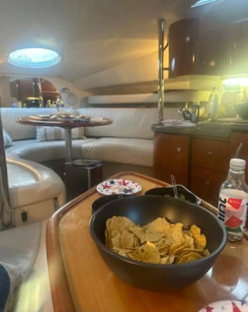 Slide: The Image of Interior of 2001 Doral 330se yacht with snacks and drinks on table. - 14