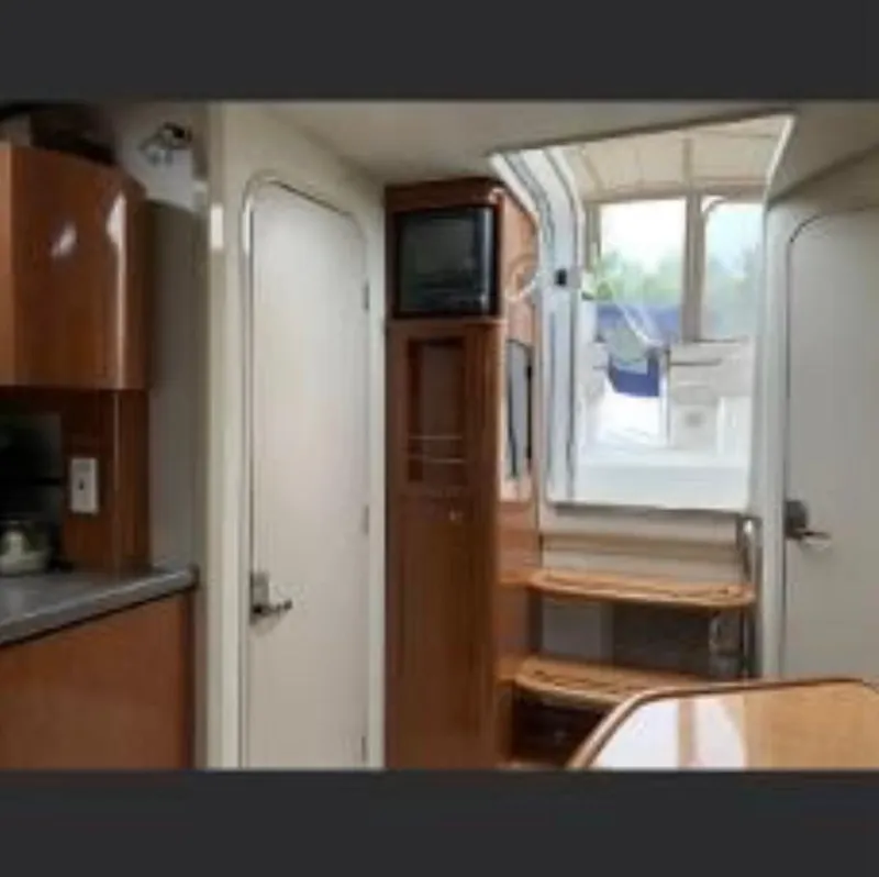 Slide: The Image of Interior of 2001 Doral 330se boat with wooden cabinetry and steps leading to deck. - 15