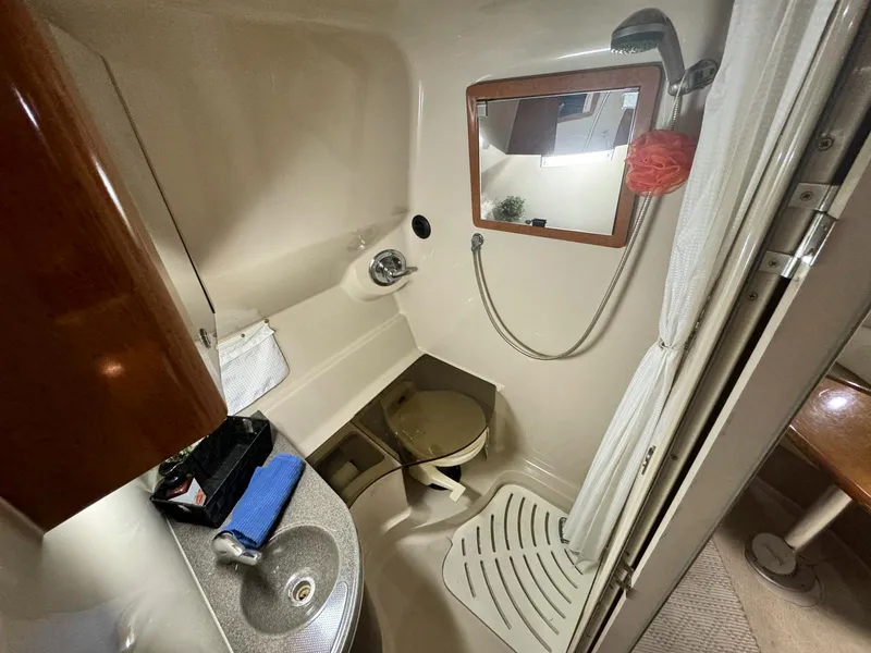Slide: The Image of 2001 Doral 330se boat bathroom with sink, toilet, and shower. - 17