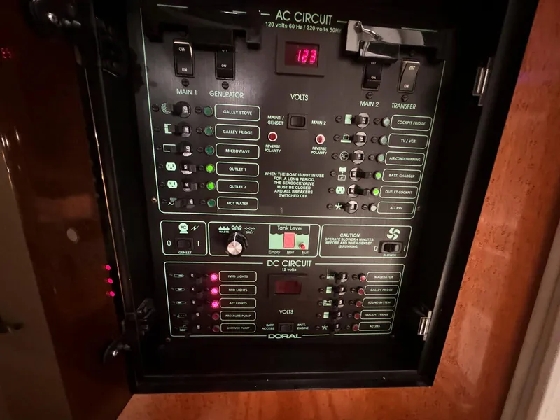 Slide: The Image of Doral 330se 2001 boat electrical panel with AC and DC circuit controls. - 21