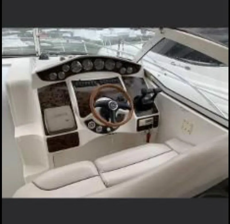 Slide: The Image of Cockpit of a 2001 Doral 330se boat with steering wheel and control panel. - 8