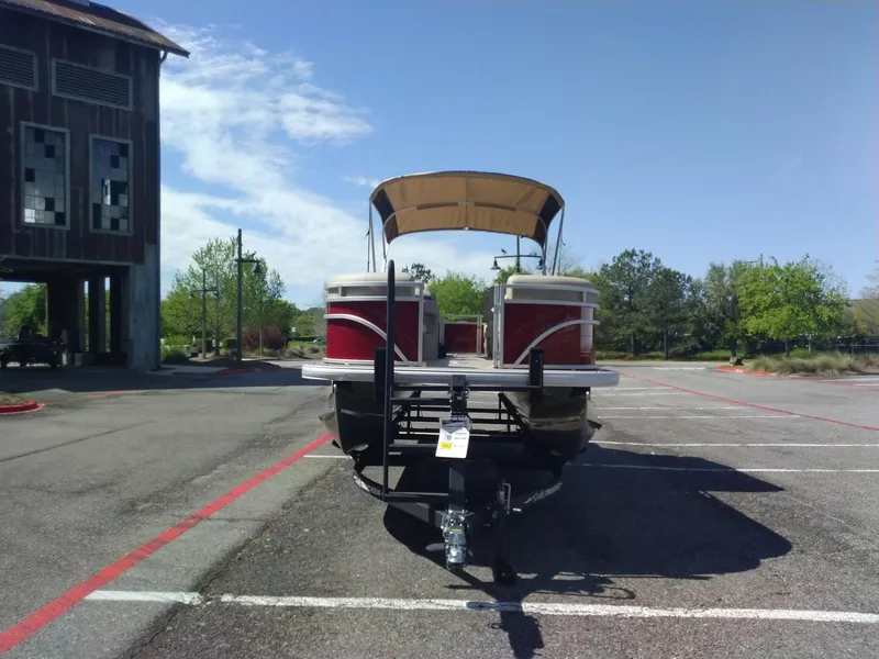 Slide: The Image of 2024 Sun Tracker Party Barge 24 DLX pontoon boat in parking lot. - 3