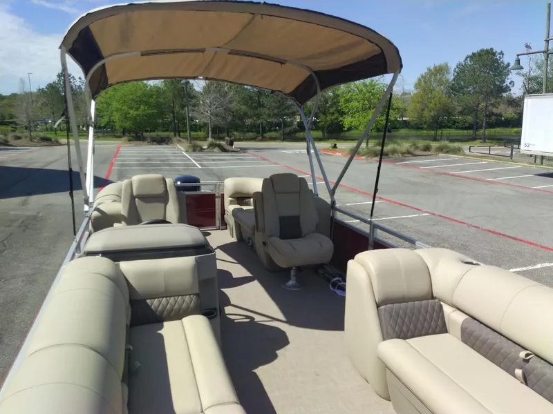 Slide: The Image of 2024 Sun Tracker Party Barge 24 DLX pontoon boat with beige seating and canopy. - 6