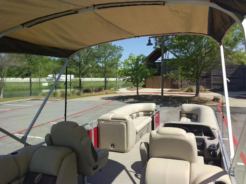 Slide: The Image of 2024 Sun Tracker Party Barge 24 DLX pontoon boat with beige seating and canopy. - 7