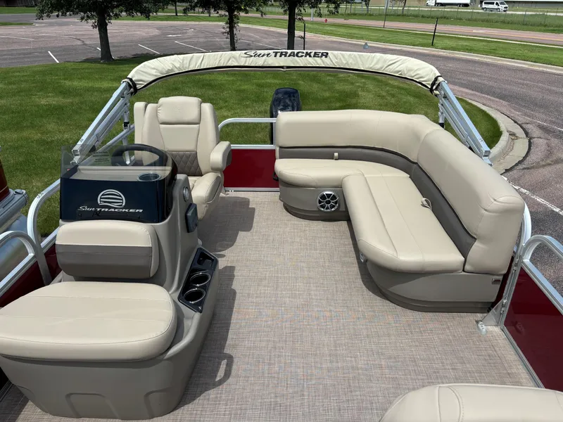 Slide: The Image of 2024 Sun Tracker Bass Buggy 16 XL Select pontoon boat with beige seating and steering console. - 6