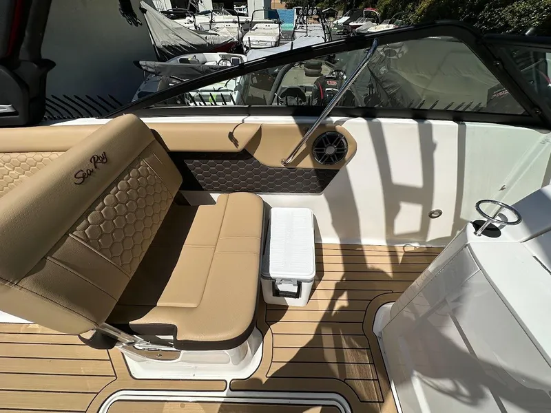 Slide: The Image of 2024 Sea Ray SDX 250 boat interior with tan seating and teak flooring. - 14