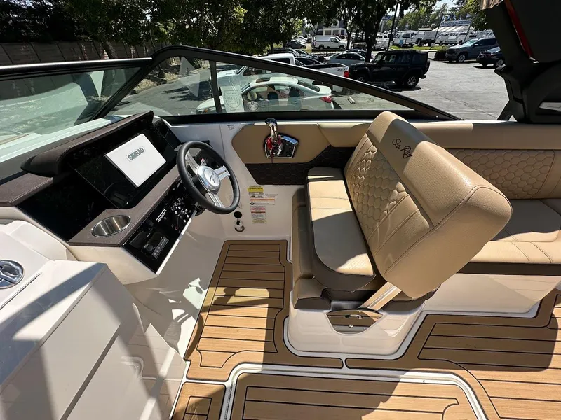 Slide: The Image of 2024 Sea Ray SDX 250 boat interior with tan seating and modern dashboard. - 15