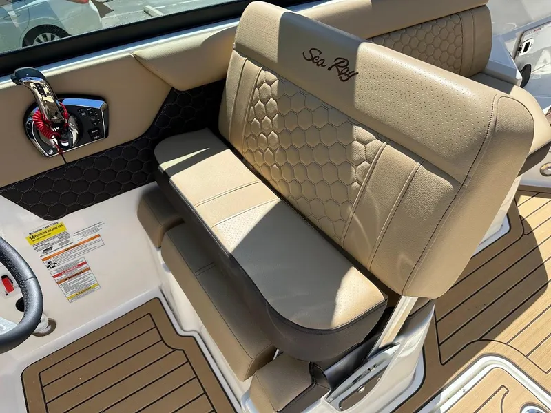 Slide: The Image of 2024 Sea Ray SDX 250 boat interior with tan leather seating and hexagonal stitching. - 20