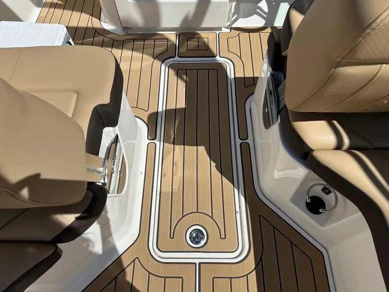 Slide: The Image of 2024 Sea Ray SDX 250 boat interior with tan seats and teak flooring. - 21