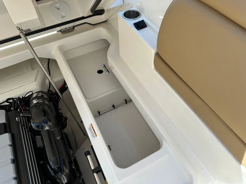 Slide: The Image of 2024 Sea Ray SDX 250 boat storage compartment and engine bay. - 25