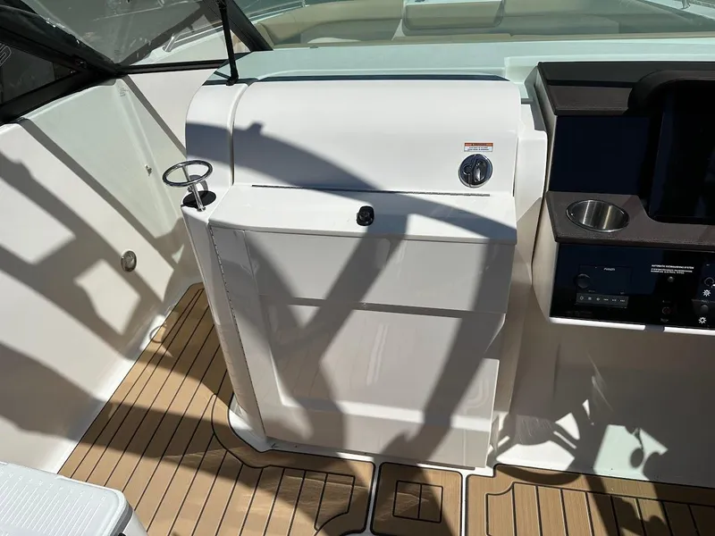 Slide: The Image of 2024 Sea Ray SDX 250 boat interior with control panel and teak flooring. - 28