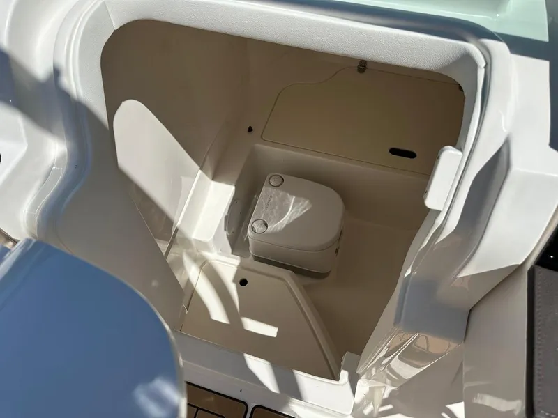 Slide: The Image of 2024 Sea Ray SDX 250 boat interior with compact marine toilet. - 29