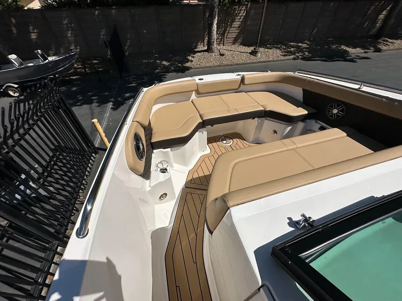 Slide: The Image of 2024 Sea Ray SDX 250 boat with tan seating and teak flooring. - 32