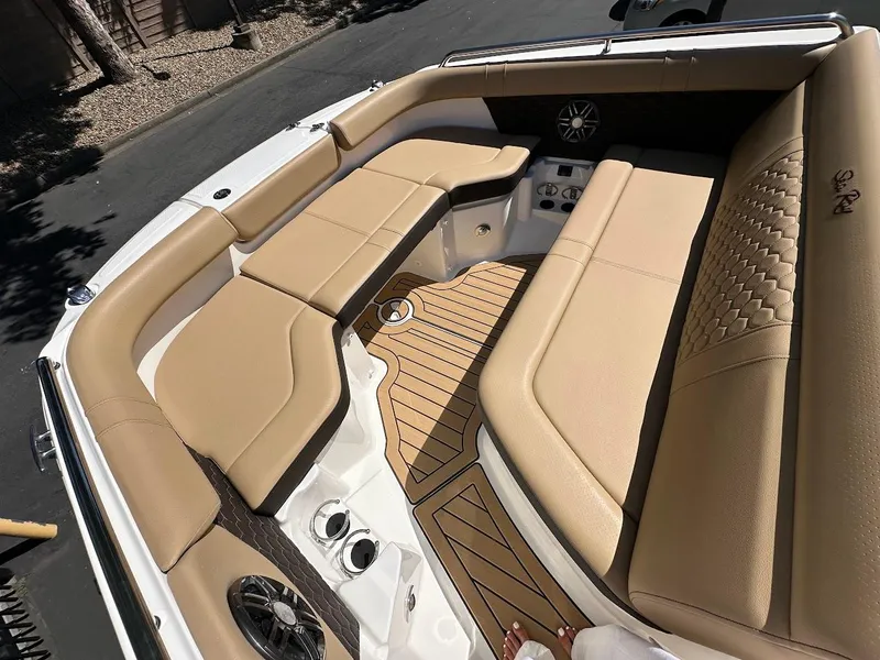 Slide: The Image of 2024 Sea Ray SDX 250 boat interior with tan seating and wood flooring. - 33