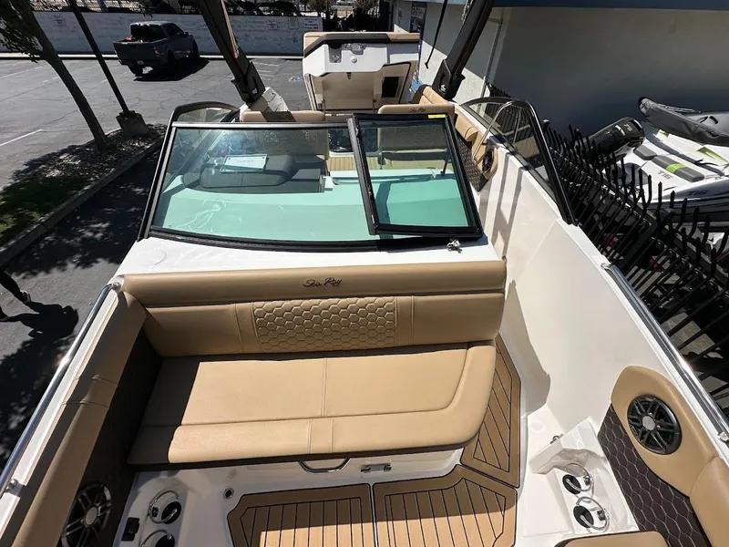 Slide: The Image of 2024 Sea Ray SDX 250 boat interior with tan seating and teak flooring. - 34