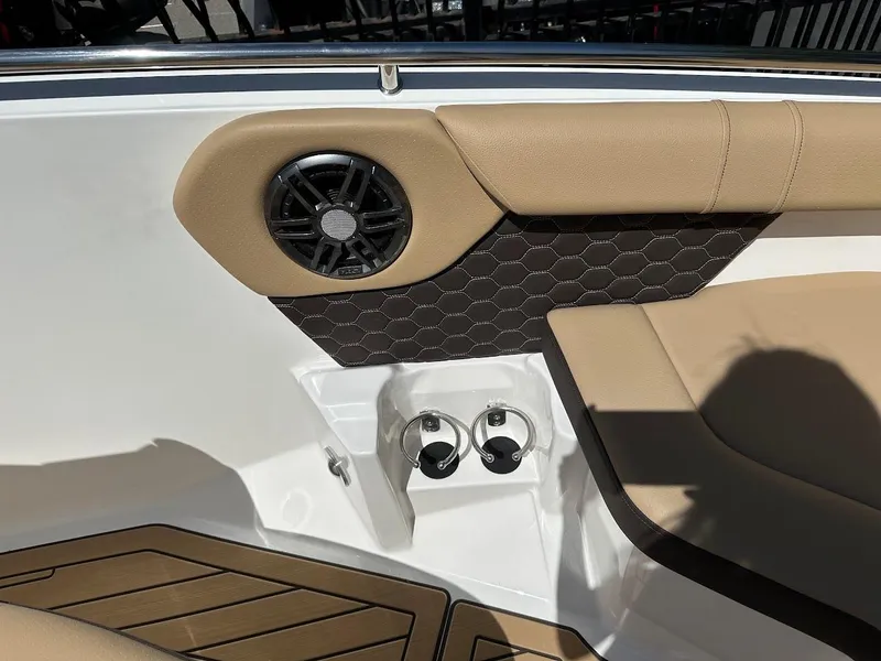 Slide: The Image of 2024 Sea Ray SDX 250 boat interior, featuring tan upholstery and built-in speakers. - 35