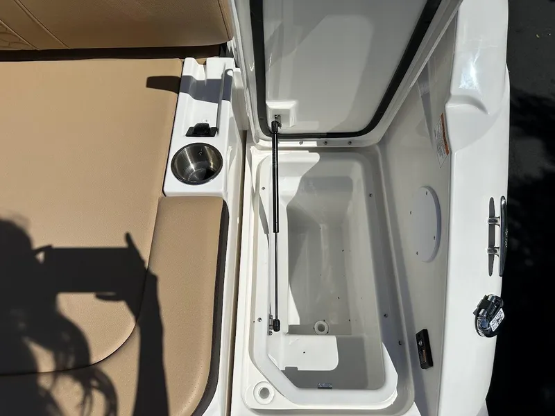 Slide: The Image of Open storage compartment on a 2024 Sea Ray SDX 250 boat with beige seating. - 39