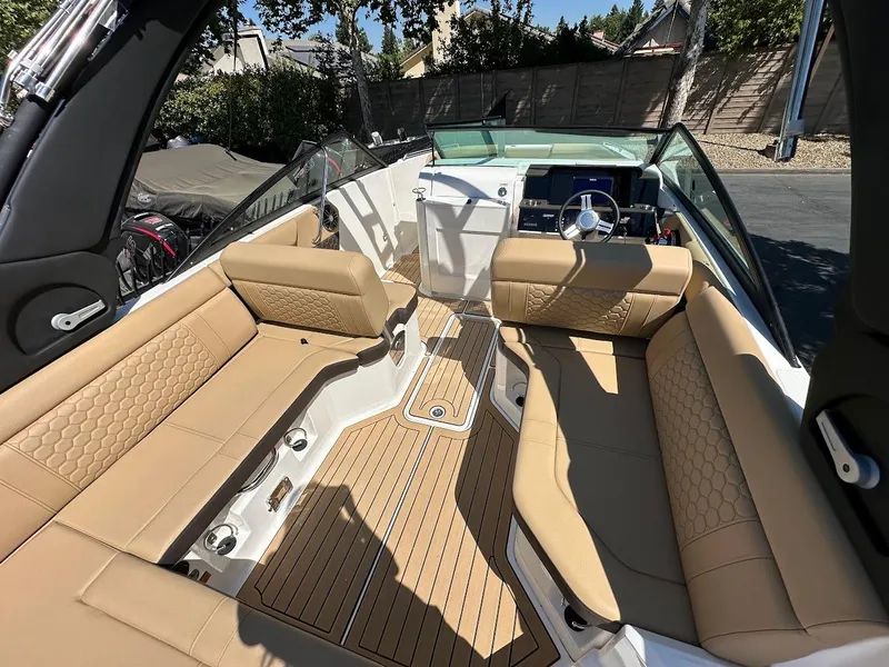 Slide: The Image of 2024 Sea Ray SDX 250 boat interior with tan seating and modern dashboard. - 41