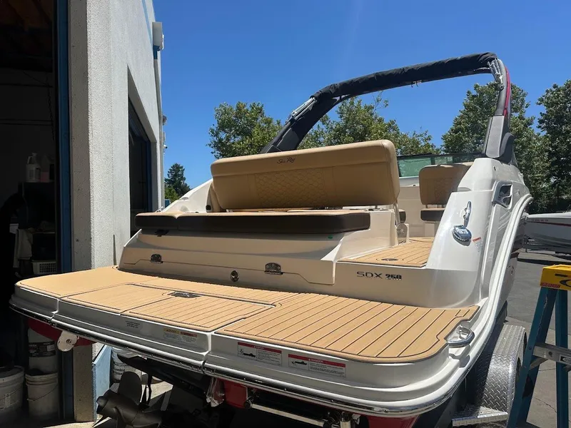 Slide: The Image of 2024 Sea Ray SDX 250 boat with tan deck and seating. - 42