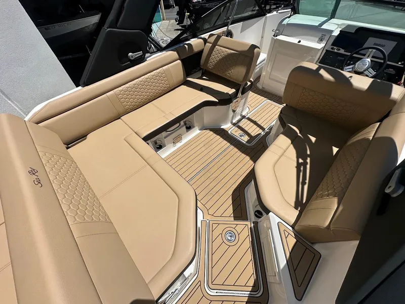 Slide: The Image of 2024 Sea Ray SDX 250 boat interior with tan seating and teak flooring. - 44