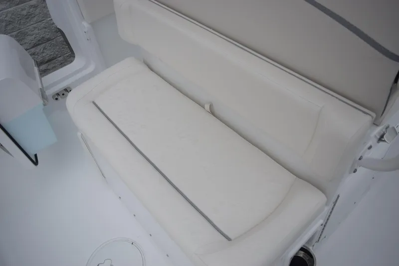 Slide: The Image of 2024 Sea Hunt Escape 27 boat, white cushioned seating area. - 10