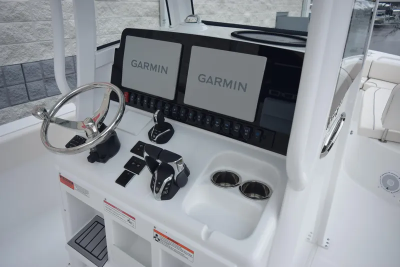 Slide: The Image of 2024 Sea Hunt Escape 27 boat dashboard with Garmin navigation systems. - 11