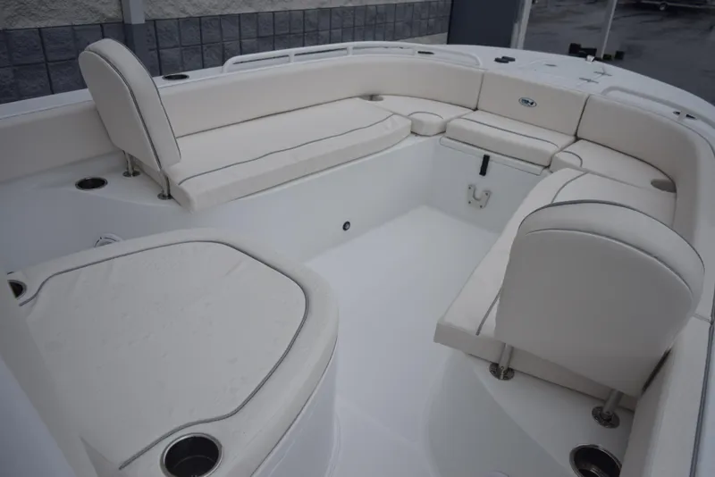 Slide: The Image of 2024 Sea Hunt Escape 27 boat interior with white cushioned seating. - 14