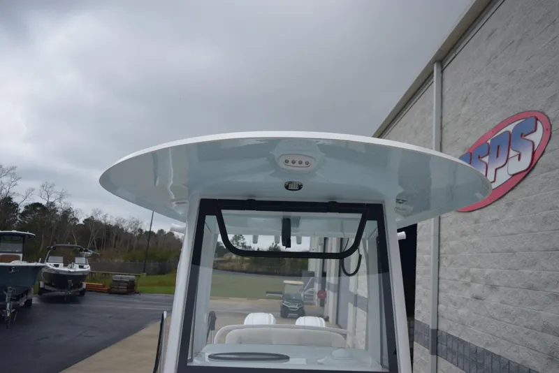 Slide: The Image of 2024 Sea Hunt Escape 27 boat, front view, parked near a building. - 16