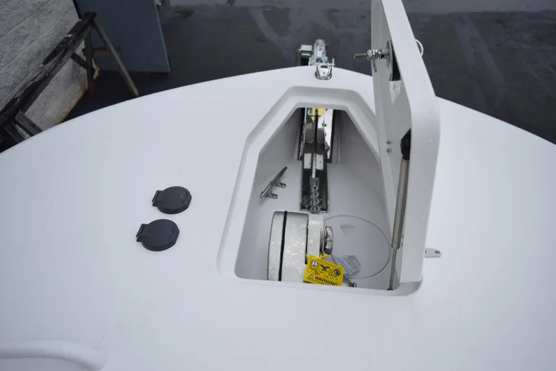 Slide: The Image of 2024 Sea Hunt Escape 27 anchor storage compartment with open hatch. - 19