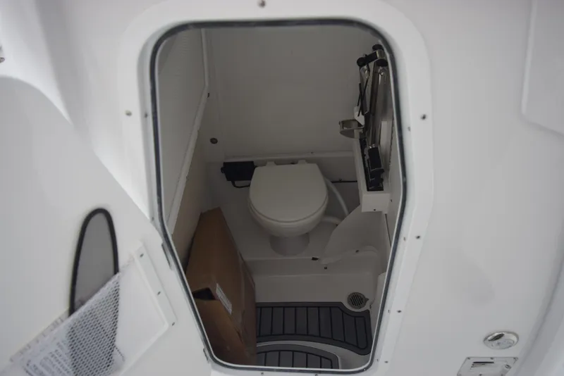 Slide: The Image of 2024 Sea Hunt Escape 27 boat interior bathroom with toilet. - 21