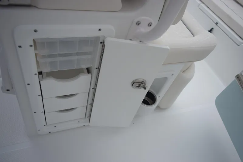 Slide: The Image of 2024 Sea Hunt Escape 27 storage compartment with open door and drawers. - 22