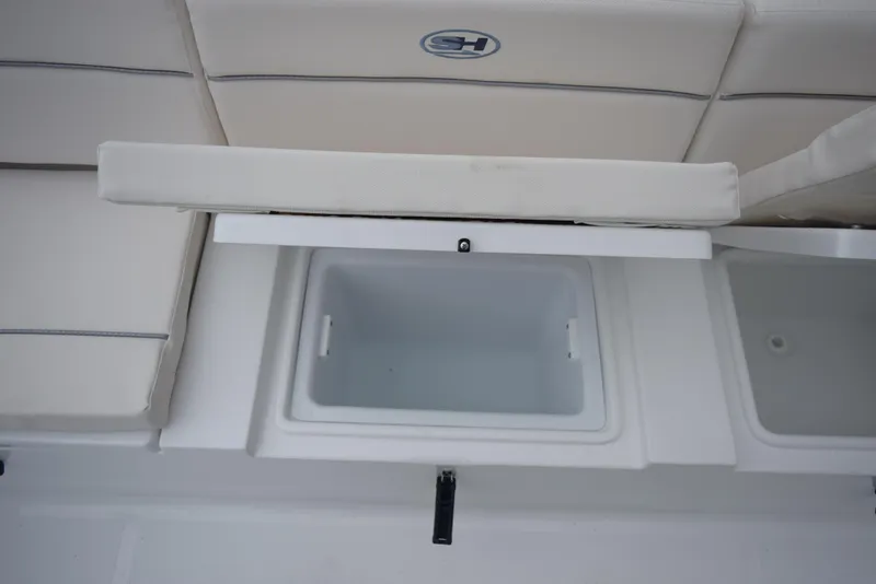 Slide: The Image of 2024 Sea Hunt Escape 27 boat storage compartment with cushioned seating. - 26