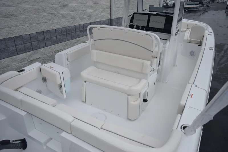 Slide: The Image of 2024 Sea Hunt Escape 27 boat interior with white seating and console. - 7