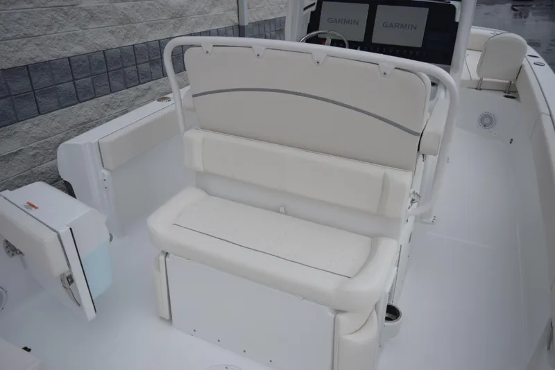 Slide: The Image of 2024 Sea Hunt Escape 27 boat interior with white cushioned seating and Garmin electronics. - 8