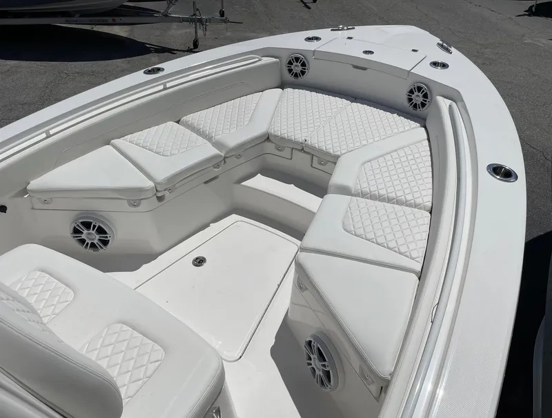 Slide: The Image of 2024 Regulator 24XO boat with white cushioned seating and built-in speakers. - 10