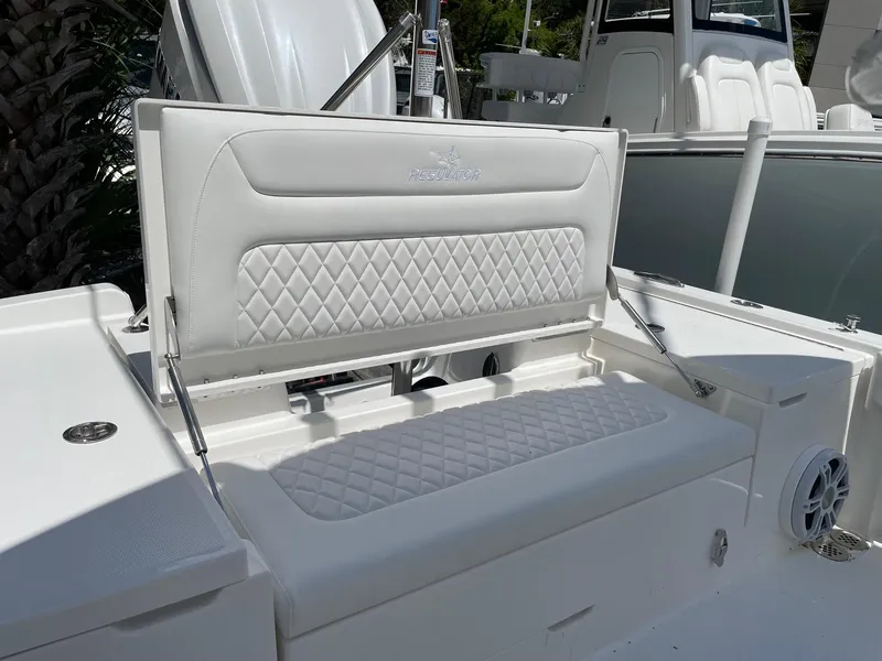 Slide: The Image of 2024 Regulator 24XO boat with white cushioned seating and diamond-stitched backrest. - 15