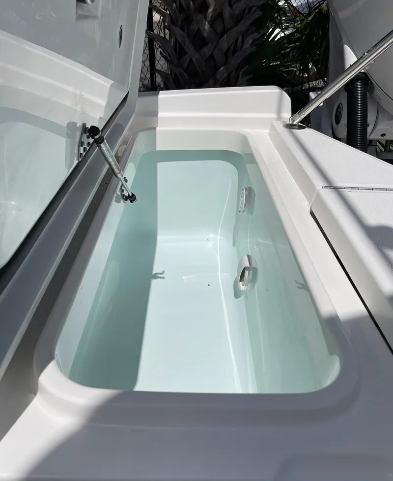 Slide: The Image of 2024 Regulator 24XO boat storage compartment with open lid. - 17