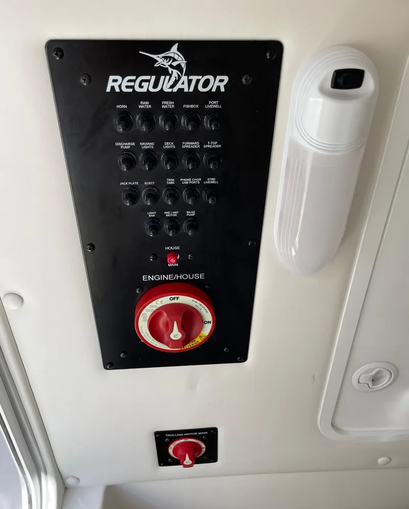 Slide: The Image of Control panel of a 2024 Regulator 24XO boat with engine house switch. - 19
