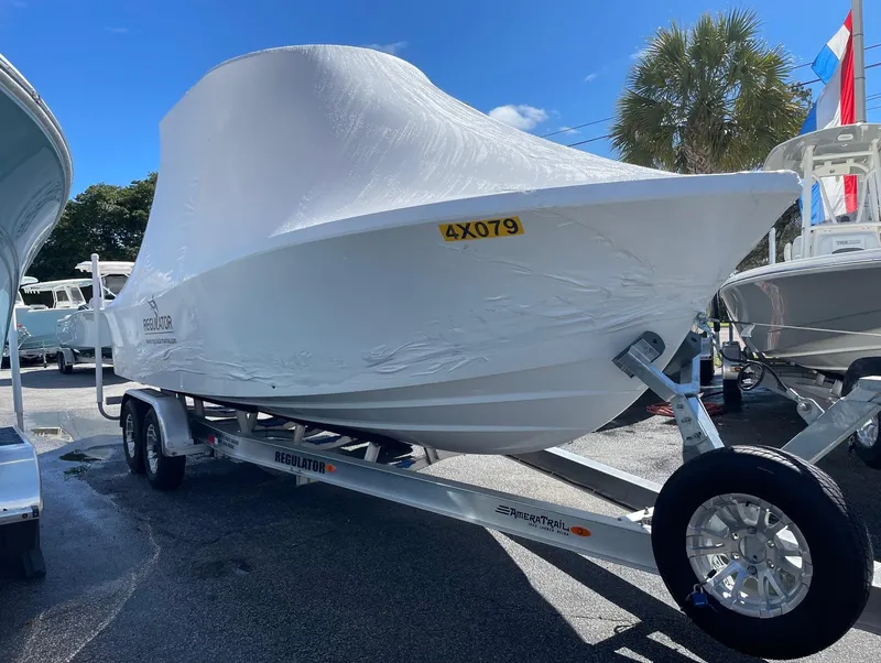 Slide: The Image of 2024 Regulator 24XO boat on trailer, covered in protective wrap. - 23