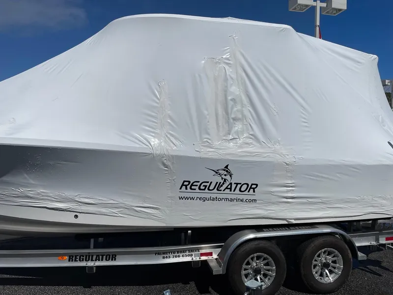 Slide: The Image of 2024 Regulator 24XO boat covered on a trailer. - 24