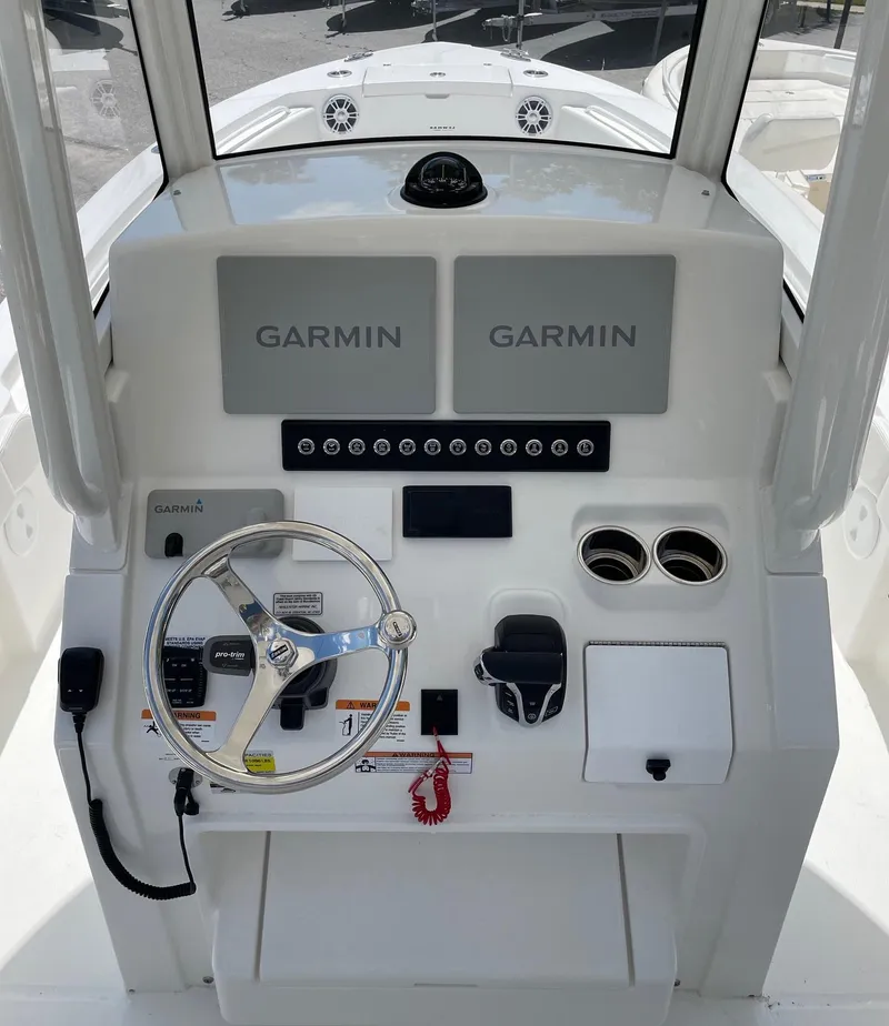 Slide: The Image of 2024 Regulator 24XO boat dashboard with Garmin navigation system and steering wheel. - 5