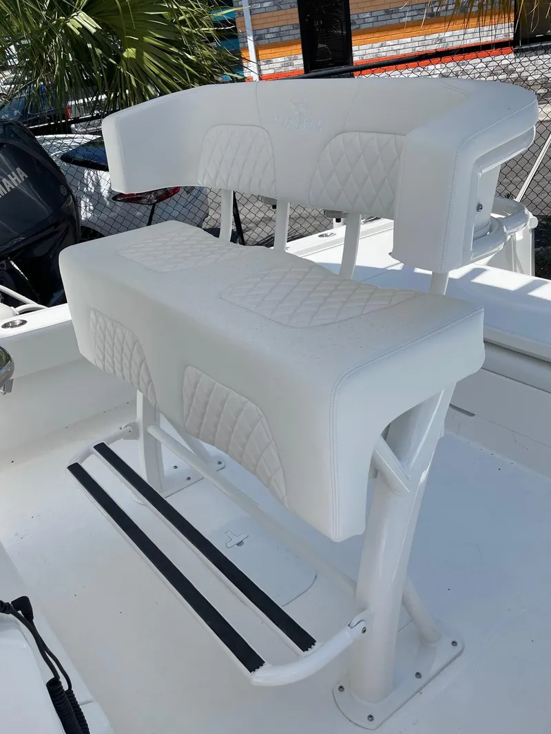 Slide: The Image of 2024 Regulator 24XO boat with white cushioned seating and footrest. - 7