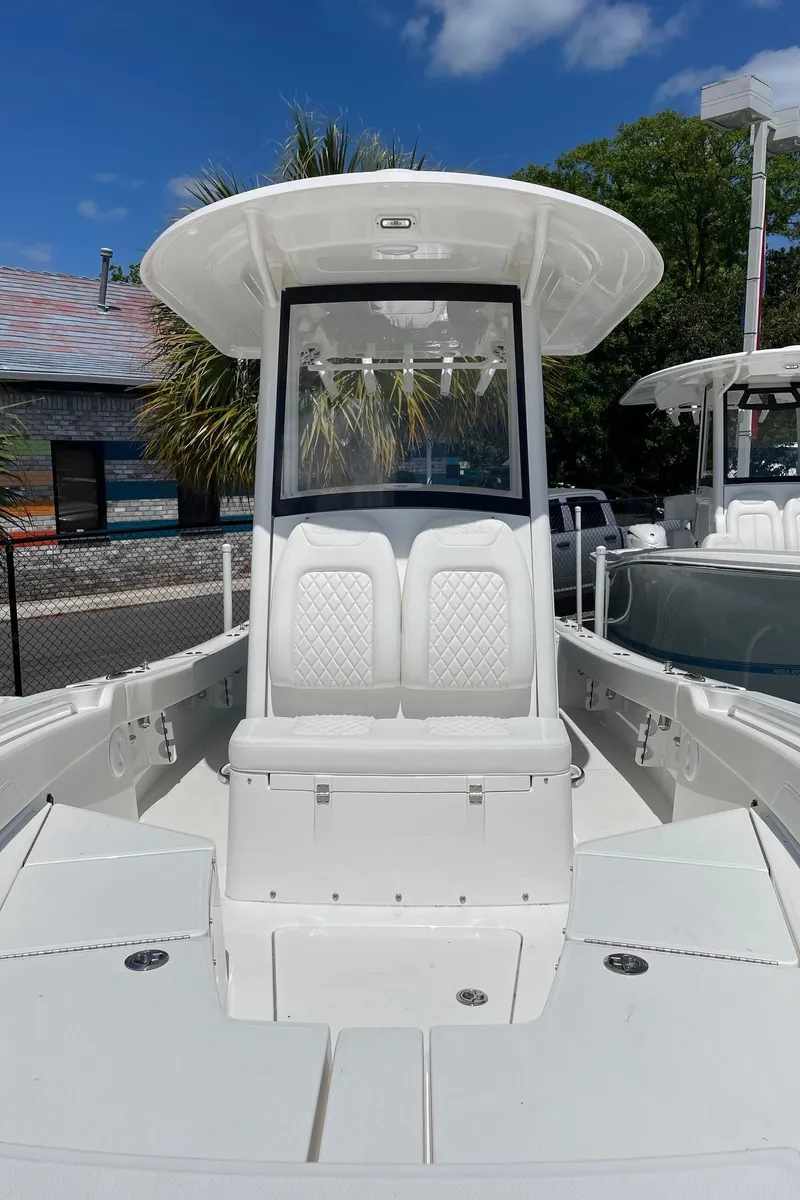 Slide: The Image of 2024 Regulator 24XO boat with center console and white seating. - 8