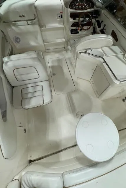 Slide: The Image of 1997 Sea Ray 280 boat interior with white seating and control panel. - 11
